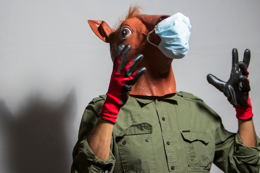 A man in Mexico City placed a surgeon's mask over a horse mask / Picture Credit: Francisco Morales/Eyepix/ABACAPRESS.COM