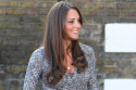 Kate Middleton dresses her growing baby bump in a chic wrap dress