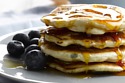 White Chocolate And Blueberry Pancakes With Maple Syrup Drizzle