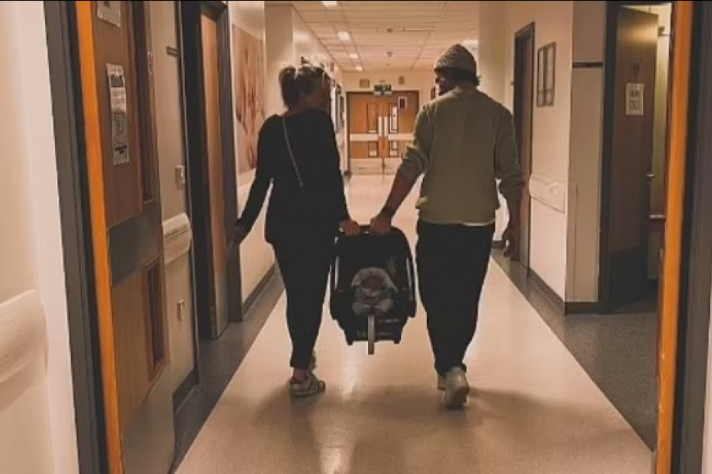 Carley Stenson and Danny Mac leave hospital with their baby