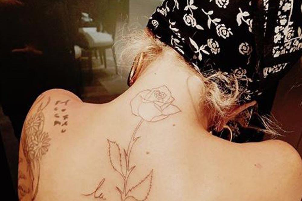 La vie en rose tattoo on top of the shoulder By