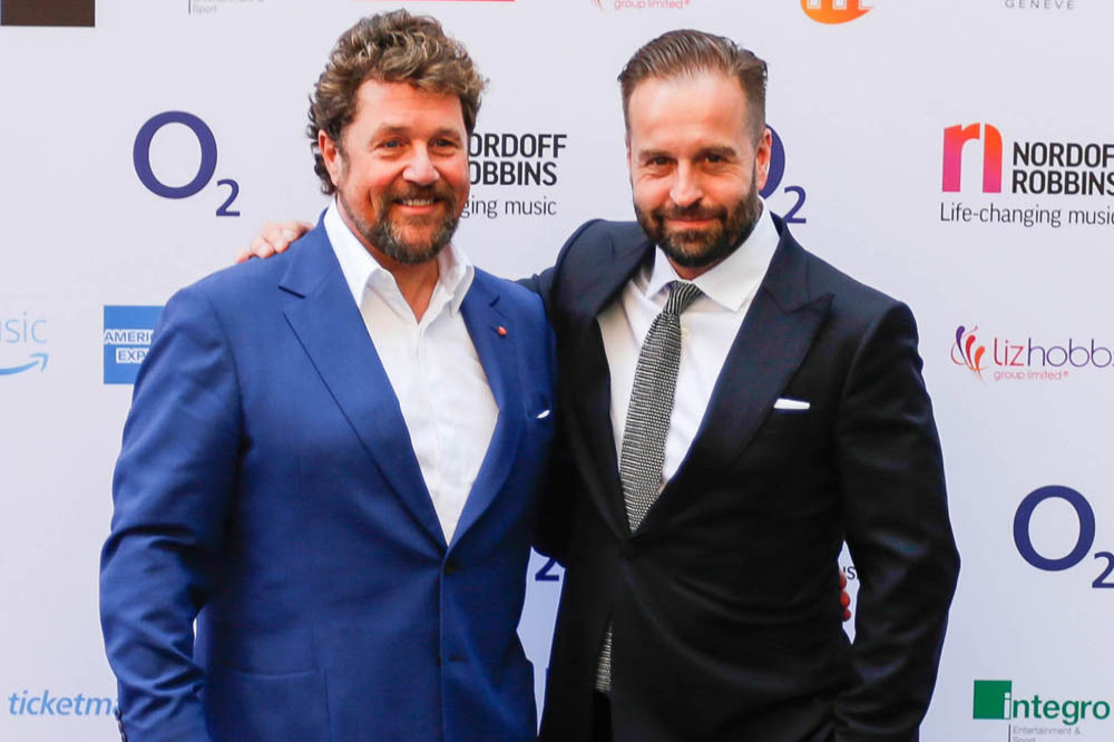 Michael Ball and Alfie Boe share a clap before going on stage