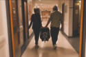 Carley Stenson and Danny Mac leave hospital with their baby