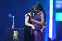 Clara Amfo hugged RAYE as she picked up her third gong of the night at the BRIT Awards 2024 with Mastercard