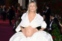 Sienna Miller wore an ostentatious Rihanna-style maternity outfit to display her growing baby bump at the Vogue World event on London