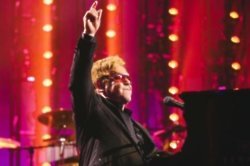 Sir Elton John has praised Prince Harry for continuing his late mother's charity work.