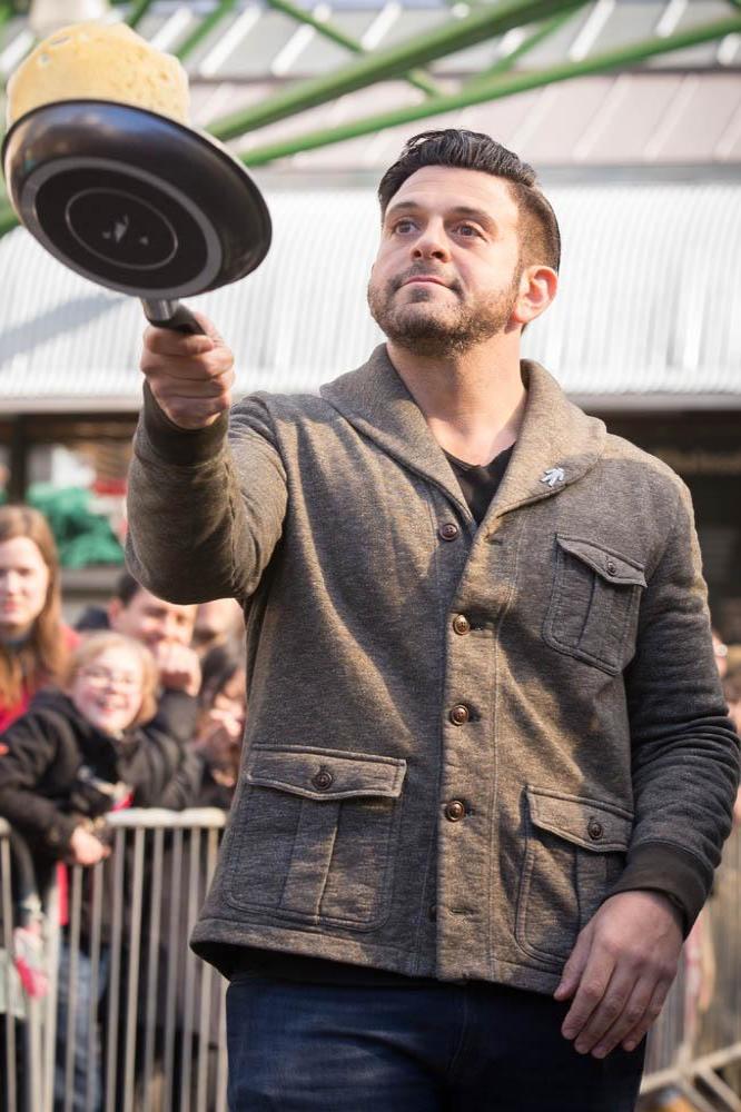 Adam Richman takes part in pancake race