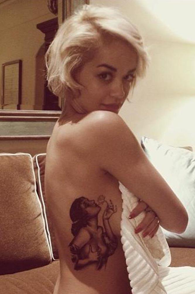 Rita Ora showing off her latest tattoo