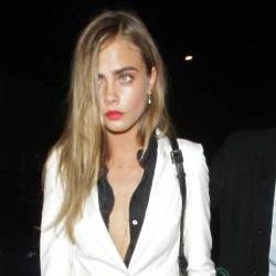 Cara Delevingne pairs her style staple with a black blouse