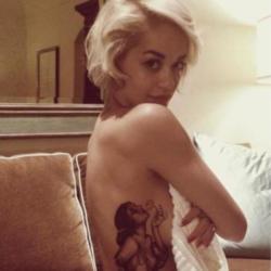 Rita Ora showing off her latest tattoo