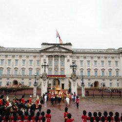 The King and Queen entering the gates of Buckingham Palace after being crowned