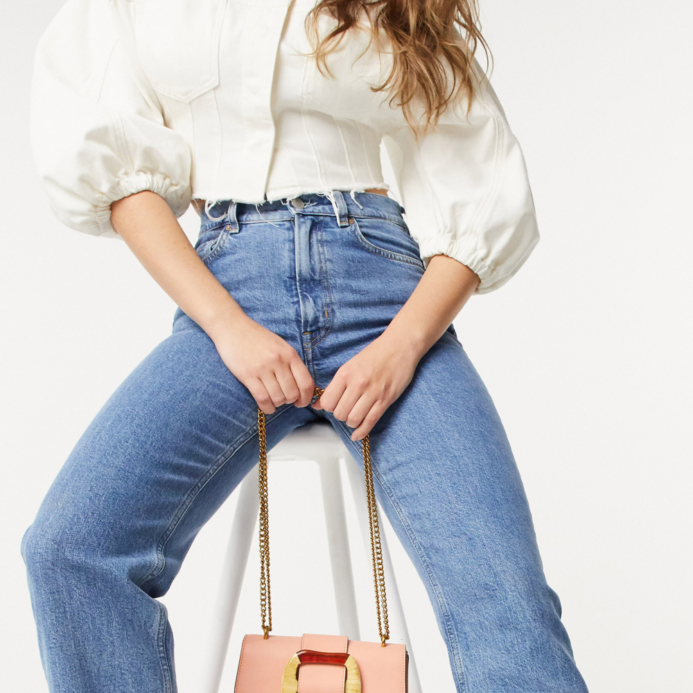 ASOS DESIGN Cross Body Bag with Statement Buckle, GBP 18; ASOS DESIGN Recycled Farleigh High Waist Slim Mom Jeans in Mid Vintage Wash, GBP 32; ASOS DESIGN Denim Seamed Top with Puff Sleeve, GBP 28, ASOS