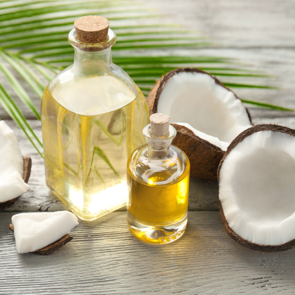 Bottles with fresh coconut oil on wooden table