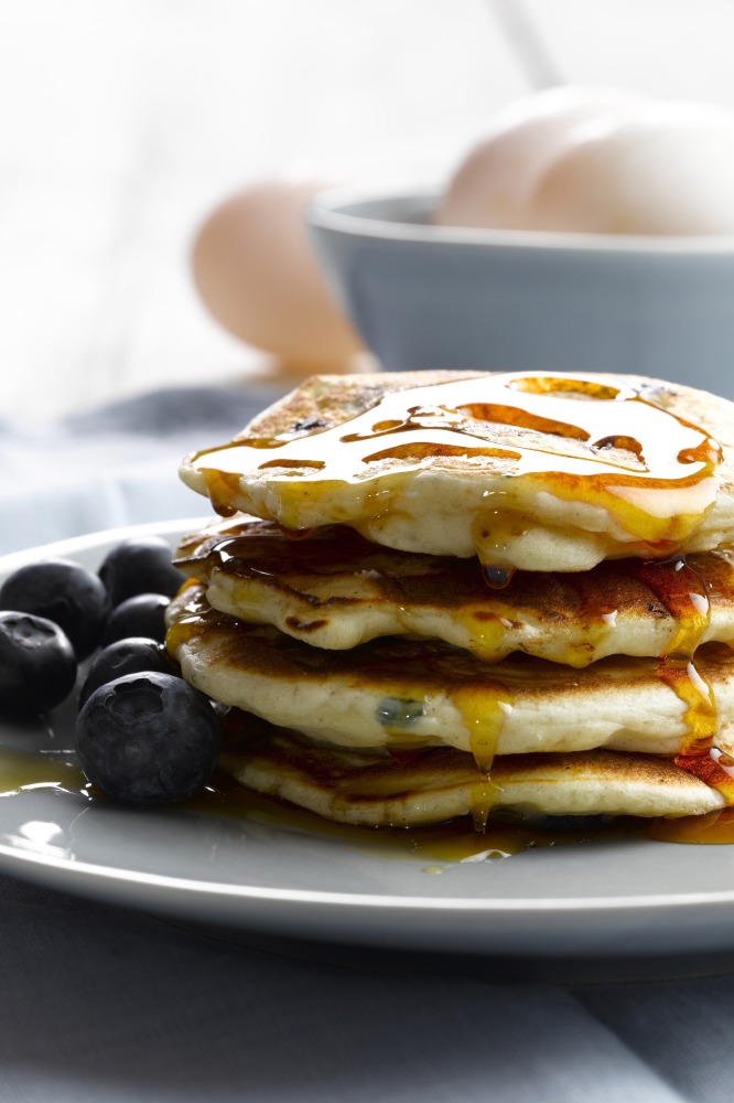 White Chocolate And Blueberry Pancakes With Maple Syrup Drizzle