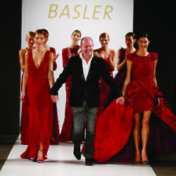 The designer takes his bow with the runway models