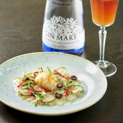 Gin Mare Cured Sea Bass with Pickled Cucumber, Black Olives, Chilli & a Scallop Beignet in Tonic Batter