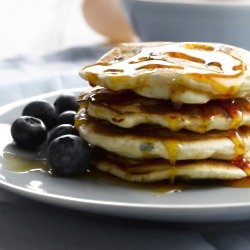 White Chocolate And Blueberry Pancakes With Maple Syrup Drizzle